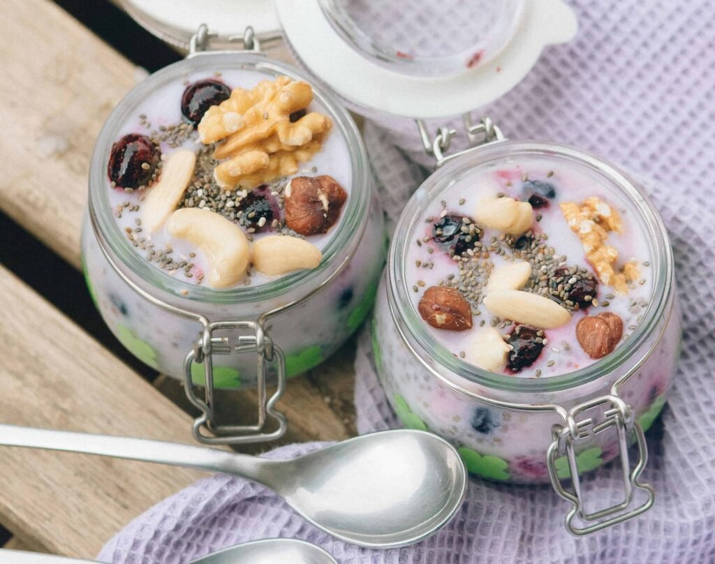 Chia seed pudding topped with almond slices and fresh fruit, a protein-rich breakfast idea for weight management