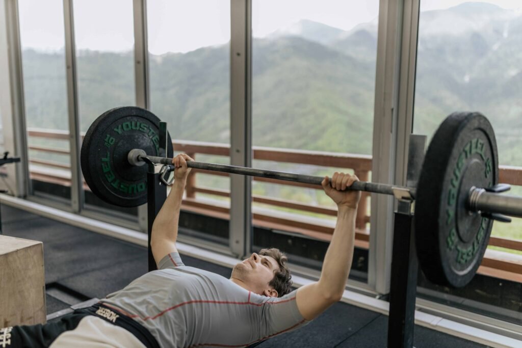 A man performing the bench press exercise in the gym