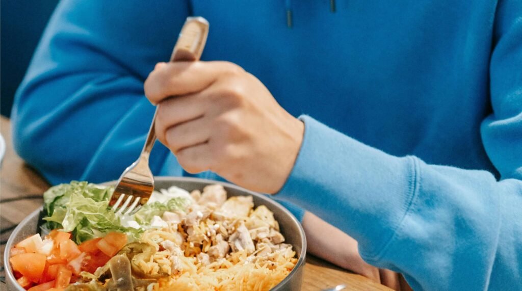 Man Eating High protein salad for Muscle Strength