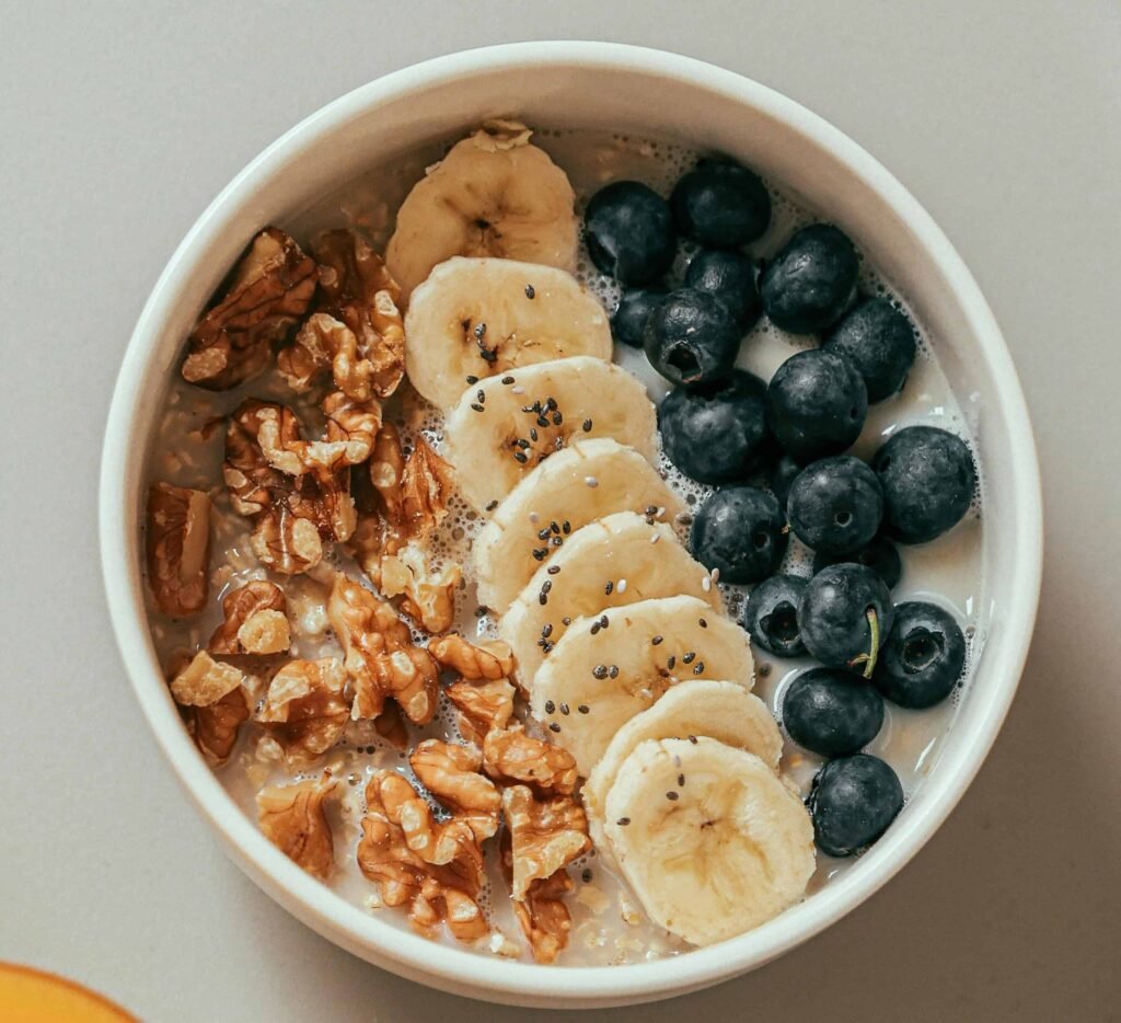 Quinoa Breakfast Bowl with protein powder, berries, and nuts, a high protein breakfast for weight loss