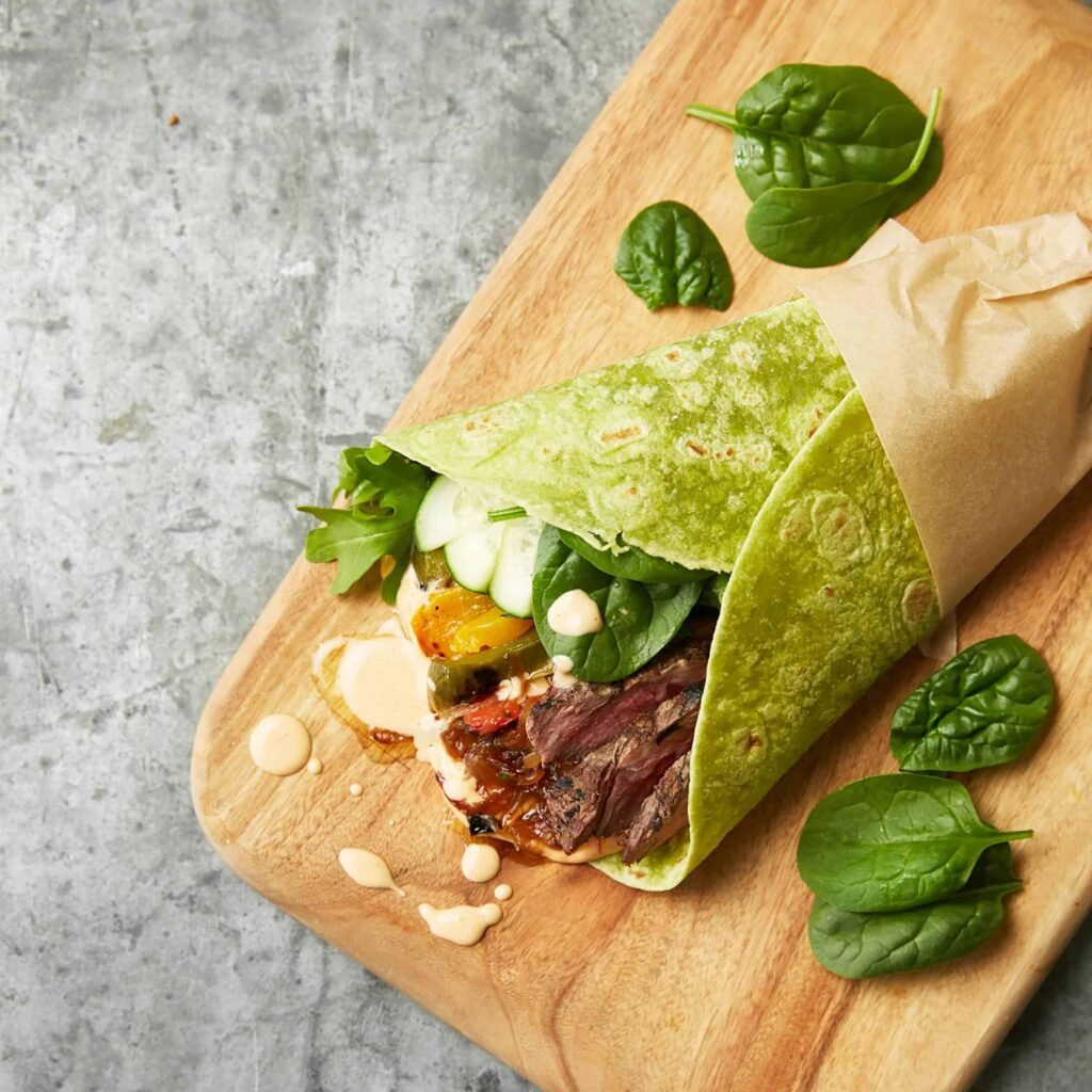 Turkey and Spinach Wrap with sliced turkey, scrambled egg whites, and a bit of cheese, a high protein breakfast idea for weight loss